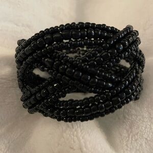 Black cuff bracelet. 4 sections of overlapping black beads. Like new.